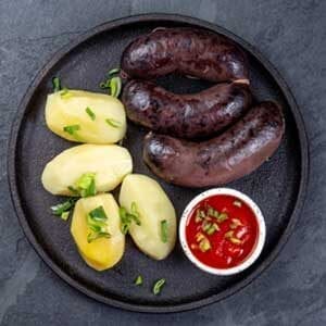 Morcilla sausage cooked with potatoes and sauce